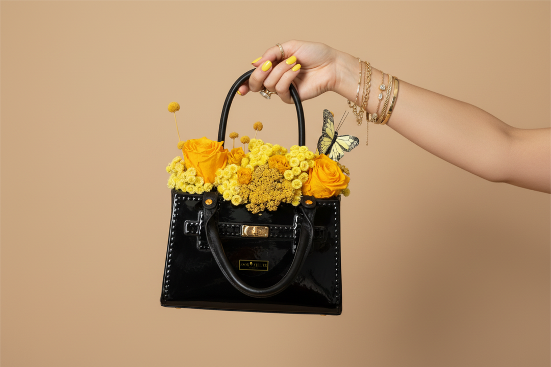 Preserved marigold flower from Esor Atelier with vibrant orange petals and green foliage, arranged naturally.