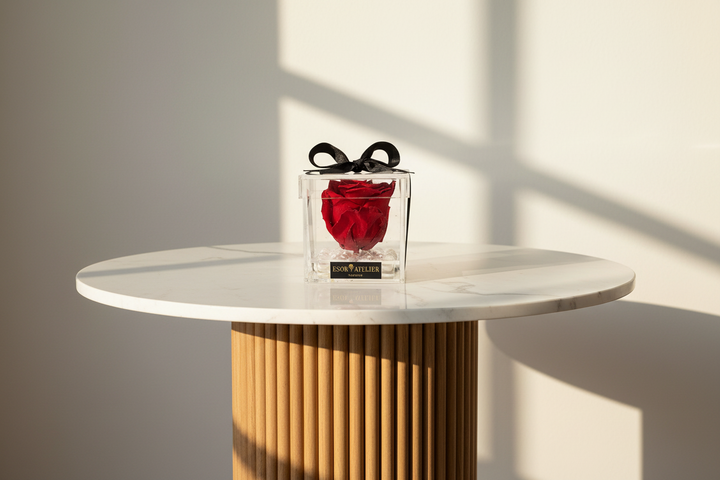 Eternal rose named Winston from ESOR ATELIER displayed in a crystal container with delicate petals and intricate details.