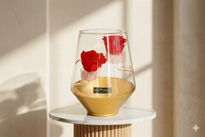Eternal rose named Mia by Esor Atelier, beautifully preserved with soft pink petals and green leaves in a clear display case.