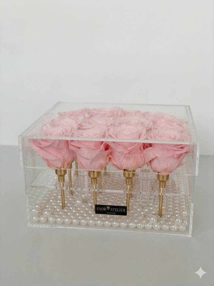 Eternal rose named Léa by ESOR ATELIER, displayed in a natural setting with soft lighting highlighting its delicate petals.