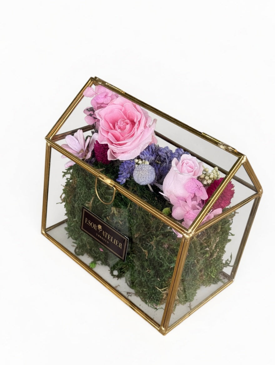 Esor Atelier Iris terrarium with lush green plants and glass enclosure, showcasing a stylish decorative home accessory.