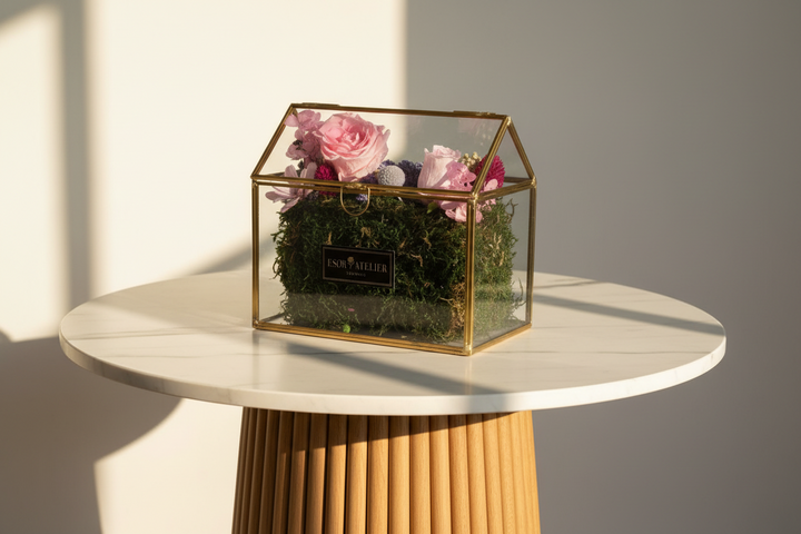 Esor Atelier Iris terrarium with lush green plants in a clear glass container, showcasing a decorative indoor plant display.
