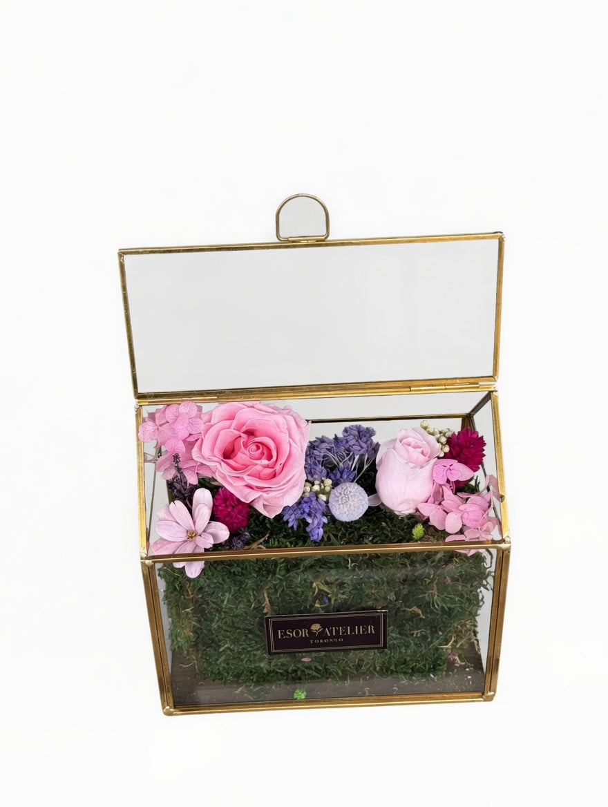 Esor Atelier Iris terrarium with lush greenery and decorative elements, showcasing a stylish glass container for indoor plants.