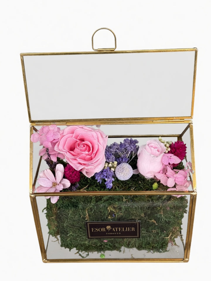 Esor Atelier Iris terrarium with lush green plants in a glass container, showcasing a decorative indoor plant display.