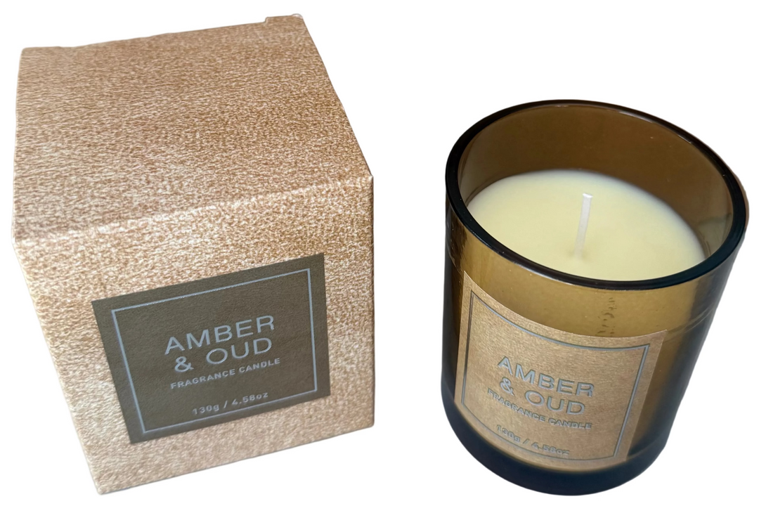 Amber &amp; OUD candle by ESOR ATELIER, elegant candle with warm amber and oud scent in a sleek glass container.