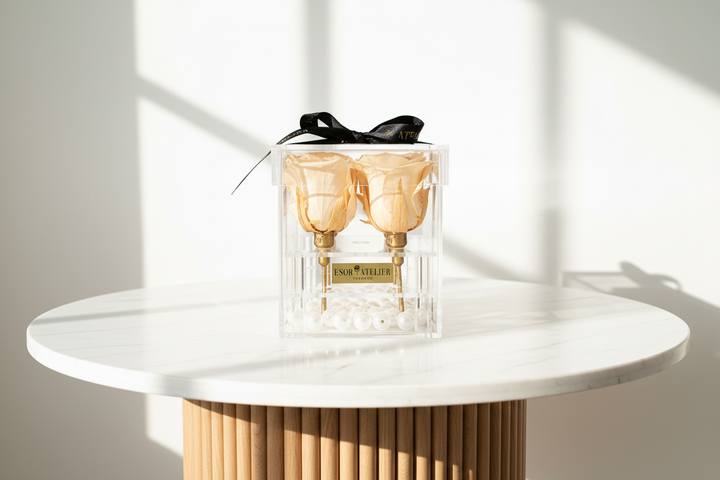 Eternal Aurora Rose by ESOR ATELIER, a preserved rose with vibrant pink petals in a clear glass display.
