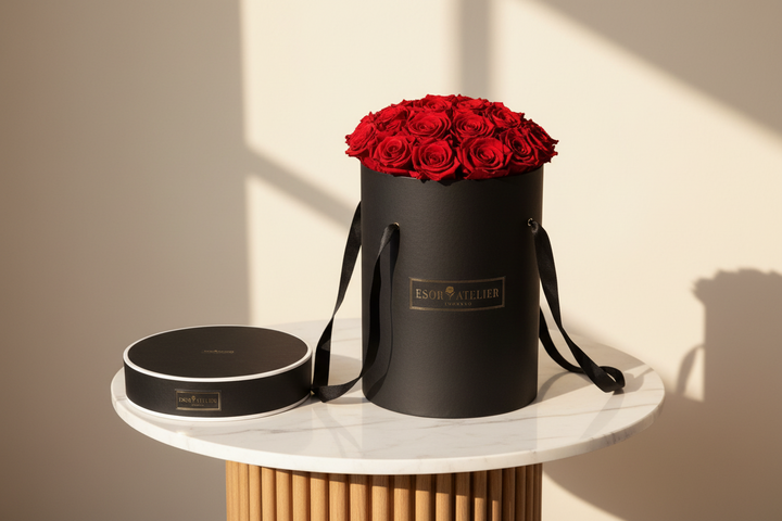 Eternal rose from Lé Noir by Esor Atelier displayed in a sleek glass dome, showcasing its vibrant, preserved red petals.