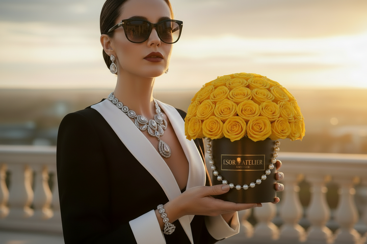 Eternal rose in a clear glass dome by Esor Atelier, showcasing vibrant petals and delicate greenery.