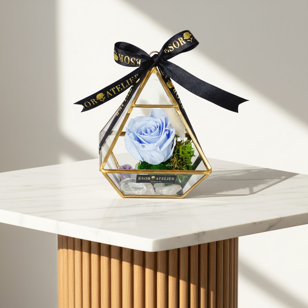 Eternal rose named Aria by Esor Atelier, beautifully preserved with soft pink petals and detailed green leaves.