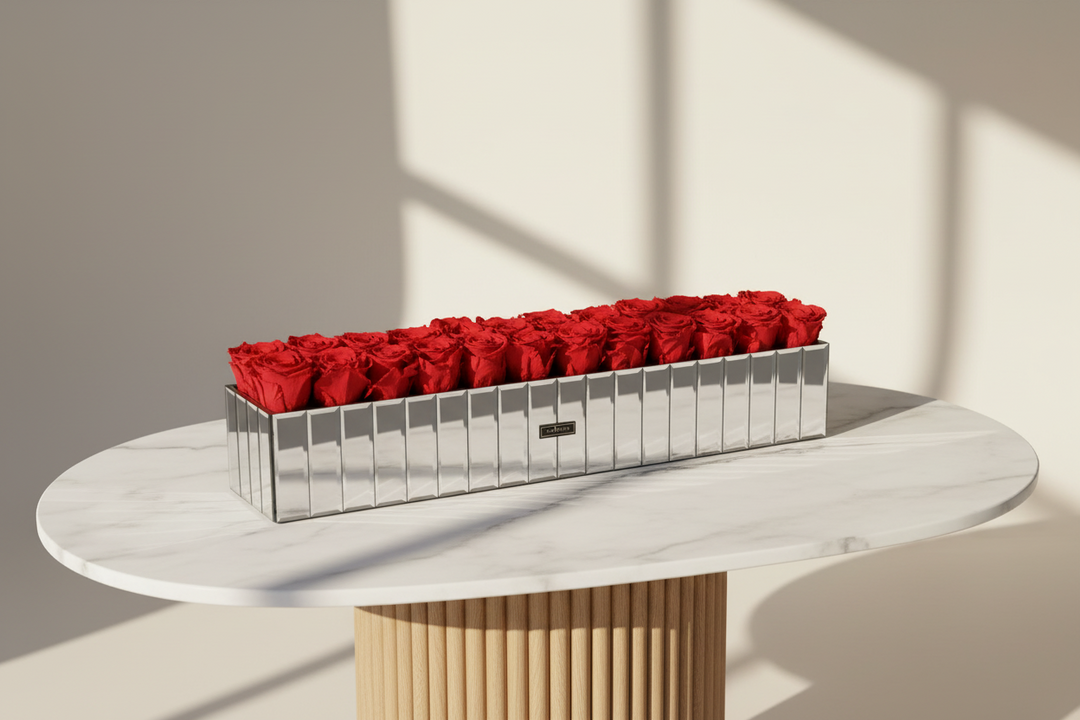 Rectangular silver container with red roses on a white table