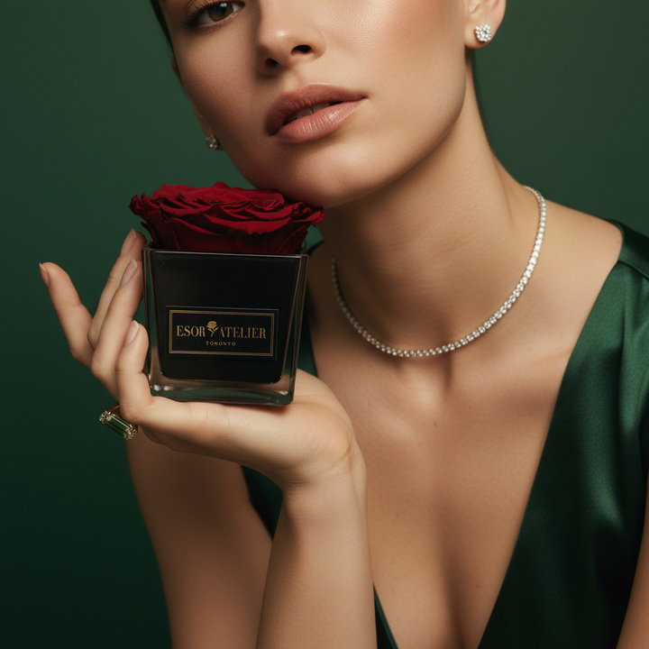 Eternal rose named Danielle by Esor Atelier, preserved in a clear glass dome with delicate petals and lush green leaves.