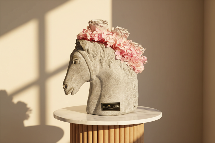 Eternal rose flower by Esor Atelier, showcasing a preserved, vibrant red rose with delicate petals and green leaves.